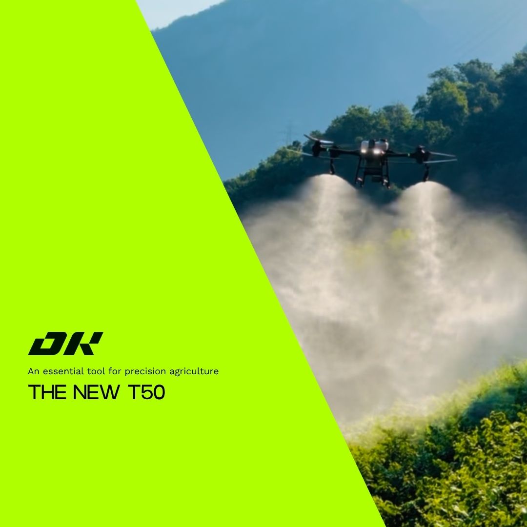 Agricultural drone spraying over green fields and hills — the T50 in action for precision farming.